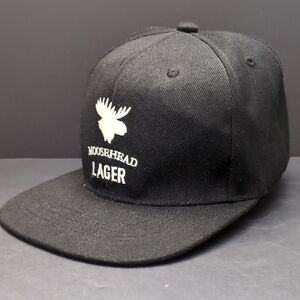 Moosehead Canadian Lager Men's Black Flat Bill Cap.